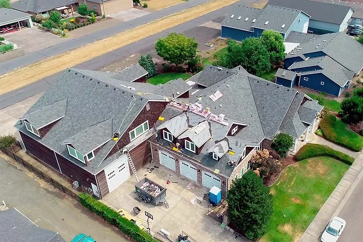 Overhead view of a house where the roof is being worked on